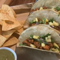 Tacos Al Pastor · Three spiced pork tacos on corn tortillas, green salsa, fresh cilantro, red onions & pineapp...