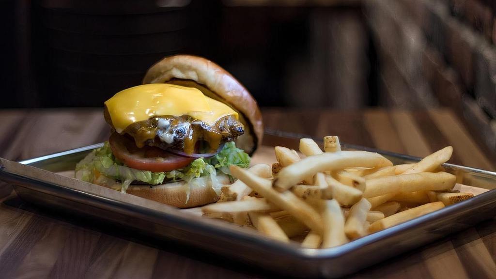 The American Burger · Shredded lettuce, tomato, American cheese, caramelized onion, 1000 island dressing.