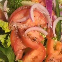 Salad / ሰላጣ · Fresh tomatoes, onions, lettuce, and greens seasoned with spiced lemon dressing.
