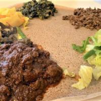 Meat Combo / የስጋ በያይነቱ · A combination of Kitfo, Gored Gored, Qey Wot, Gomen and cabbage.