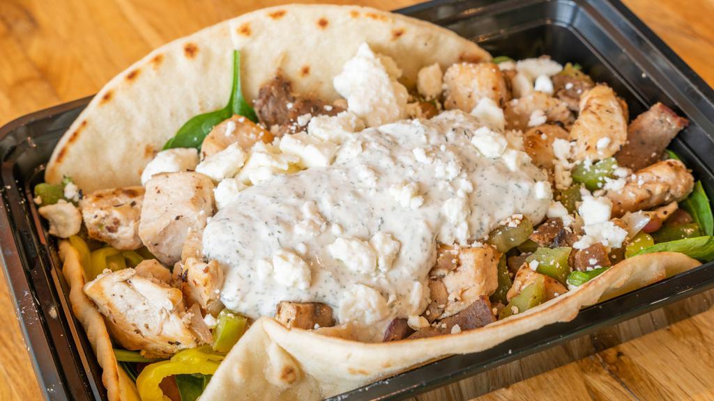 The Hercules · Chicken and Gyro cooked in our Secret Sauce! With a Choice of Greens, Grilled Mushrooms, Grilled Onions, Grilled Peppers, Tomato, Banana Peppers, Feta, and Tzatziki