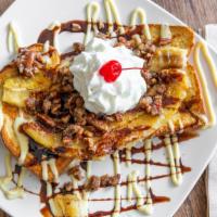 Banana Split · Vegetarian. Contains nuts. Two pieces of our French toast topped with vanilla crème and cara...