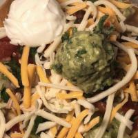 Taco Salad · Taco bowl shell, filled with beans, rice, shredded lettuce, guacamole, pico De gallo, and yo...