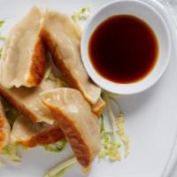 Pot Stickers (6) · Dumpling filled with ground pork and vegetables.