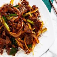 Mongolian Beef 蒙古牛 · Sliced tender marinated beef with green onion and garnished with fried noodle vermicelli.