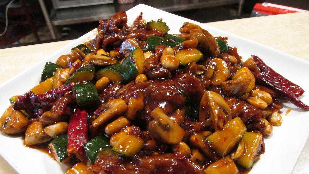 Kung Pao Beef 宫爆牛 · Sliced tender beef sauteed in spicy sauce and topped with peanuts.