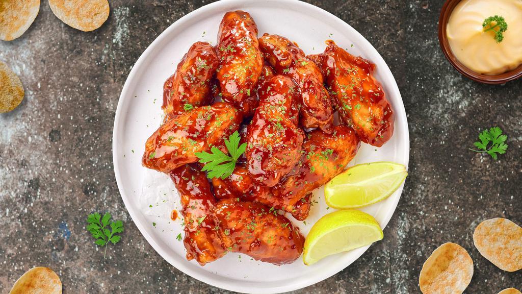 Honey Glazed Wings · Breaded or naked fresh chicken wings, fried until golden brown, and tossed in honey & hot sauce. Served with a side of ranch or bleu cheese.