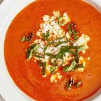 Bowl Of Tomato Basil Soup · Made with fresh tomatoes, basil, onions, garlic, and thyme. Topped with feta cheese and fres...