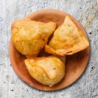 Savage Samosa · Cumin-flavored potatoes and peas filled in pastry dumpling and golden fried.