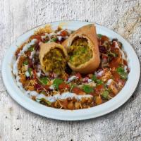 Samosa Cluster · Veggie samosas, crushed and mixed with hot, sweet, and tangy sauces, yogurt, and topped with...