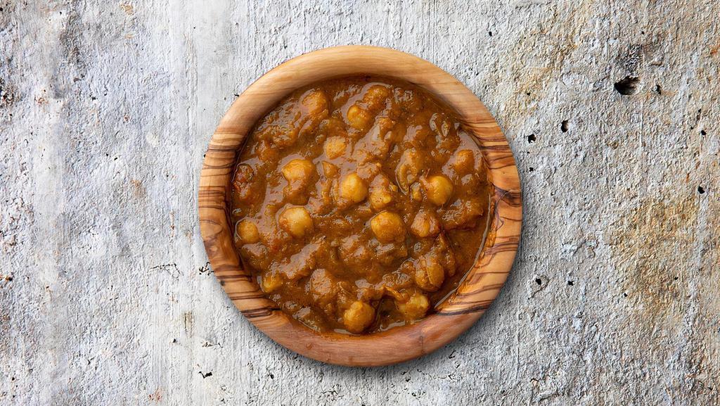 Chickpea Capital · Chickpeas cooked in curry with onions, juicy tomatoes, and perfectly grounded spices.