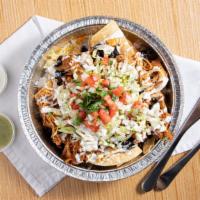 Super Nachos · House-made  chips, rice, beans, lettuce, cheese, pico & chipotle cream.