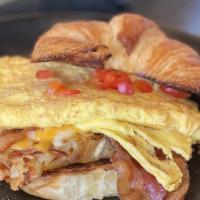All American · Bacon, eggs, cheesy hash browns, peppers, and cheese on a flaky croissant.