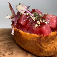 Tuna Poke Inari Bomb · Inari, Diced Fresh Tuna, Furikake, Micro Greens, Sushi Rice, Poke Sauce, and Unagi Sauce.