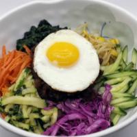 Regular Bibimbop · An assortment of vegetables with your choice of meat and sauce with a fried egg on top over ...