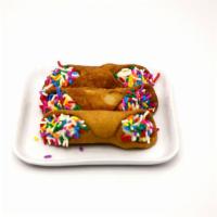 It'S A Party · 3 cannoli filled with a lemon cream cheese buttercream and dipped in rainbow sprinkles.