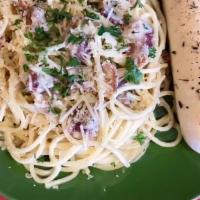 Bacon Carbonara · Piping hot spaghetti tossed in a parmesan, garlic cream sauce mixed with fresh cooked bacon.