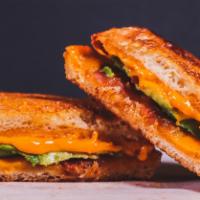 Bacon Avocado Grilled Cheese · Melted Cheddar, bacon, and avocado between two slices of buttery grilled bread.