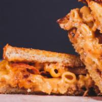 Mac Grilled Cheese · Creamy classic mac and cheese with crispy bacon on two slices of buttery grilled bread.