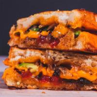 Veggie Grilled Cheese · Melted Cheddar cheese, ripe avocado, tomato, grilled onions, roasted red peppers, and mayo b...