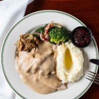Roast Young Tom Turkey · The traditional house specialty. Served with sage dressing choice of fresh mashed potatoes o...