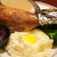 Roast Turkey Drumstick · Tender roasted turkey drumstick served with sage dressing, fresh mashed potatoes or fresh ba...