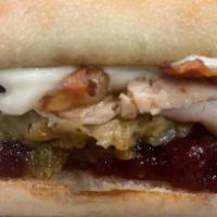 Thanksgetting · Sliced turkey, crispy bacon, cranberry sauce, stuffing, gravy, and rosemary aioli on a teler...