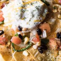 Nachos · Attic corn tortilla chips topped with a cheddar jack cheese blend, housemade salsa, black be...