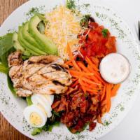 Cobb Salad · Mixed greens topped with bacon, hard-boiled egg, avocado, shredded cheese blend, grilled chi...