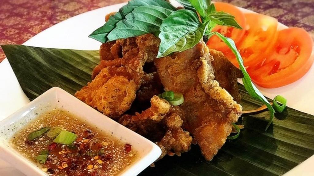 Crispy Pork Belly (8) · Deep fried pork belly marinated with Thai seasoning with roasted rice powder 
lime chili dipping sauce