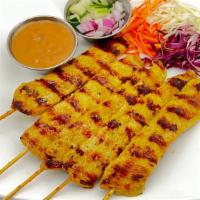 Chicken Satay (5)(Gf) · Marinated chicken on skewers served with peanut sauce and cucumber salad.