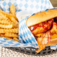 Cowboy Burger · Half pound Angus beef patty, onion rings, BBQ, bacon, cheddar cheese on a toasted brioche bun.