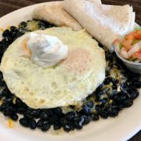 Huevos Rancheros · Black beans topped with cheese and 2 eggs any style, sour cream, and pico de gallo. Served w...