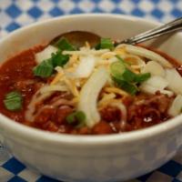 Homemade Chili · A bowl of our house-made chili, topped with cheese and onion. Served with delicious Yummy! g...