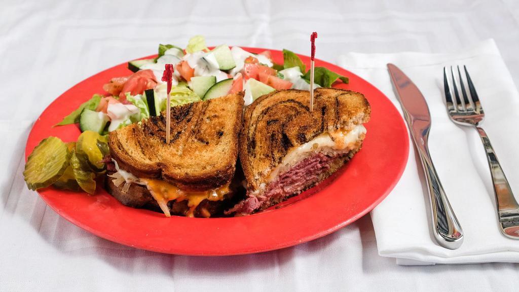 Reuben · House-made corned beef, sauerkraut, swiss cheese and thousand island dressing on grilled rye. Served with French fries.