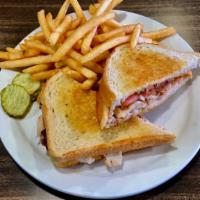 Turkey Melt · Turkey with bacon, tomato and cheddar cheese, served on grilled sourdough. Served with Frenc...