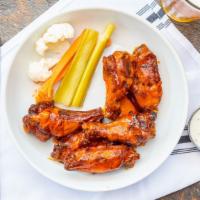Smoked Chicken Wings · Smoked wings, traditional, lemon pepper, BBQ, honey sriracha, and diablo.