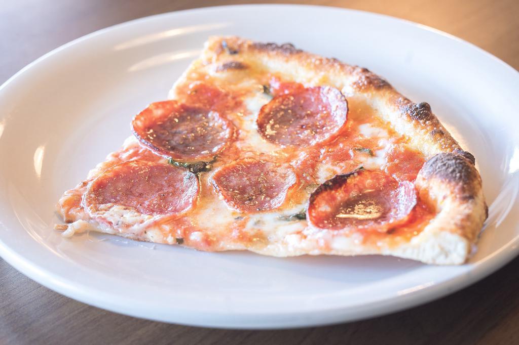 Salami Pizza · Tomato sauce, fresh mozzarella, salami, basil, and grana padano.