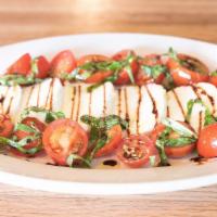 Caprese Salad · Cherry tomatoes, basil, balsamic reduction, extra virgin olive oil and fresh mozzarella.