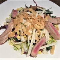 Seared Ahi Salad · Kale, shaved brussels sprouts, edamame, corn, jicama, radicchio, cabbage, and wonton strips ...