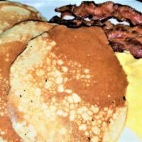 Pancake Sandwich · Three pancakes with two egg and two strips of bacon or two sausage links.