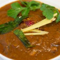 Andhra Chicken Curry · Chicken cubes cooked in a traditional brown gravy with herbs and specialty andhra masala.