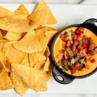 Carnitas Queso · Housemade spicy queso topped with tender pork and garnished with pico de gallo. Choice of to...