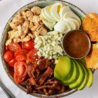 Cobb Salad · A bed of romaine with fresh avocado, thick-cut bacon, blue cheese, grape tomatoes, and hardb...