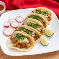 Al Pastor Taco · Seasoned pork. Served with corn tortilla, cilantro and onion.