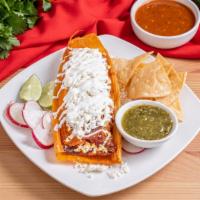 Tamal De Pollo En Salsa Roja · Chicken in red sauce. served with sour cream and cheese.