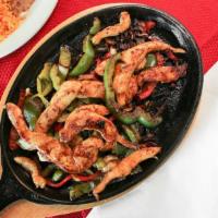 Chicken Fajitas · Fajitas are marinated in a special prepared sauce served with onions bell peppers lettuce ch...