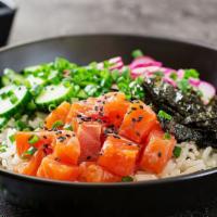 The Poke Bowl · Delicious, seasoned raw fish tossed over steamed white rice and topped with fresh vegetables.