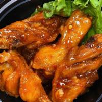 Bangkok Chicken Wings - 6 Pcs · Non-battered fried wings. Glaze with Khan Toke's special sweet & spicy sauce.