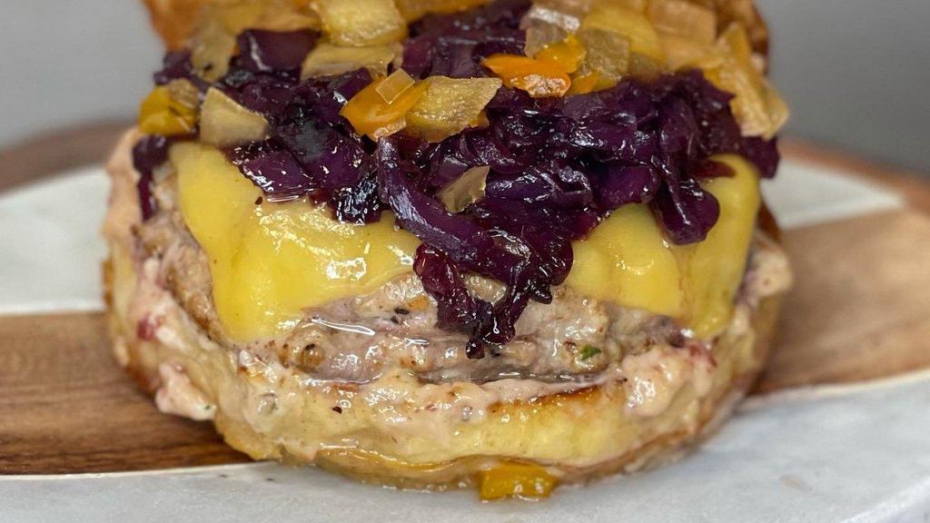 Duck Burger · Maple Leaf farms ground duck patty, gouda cheese, red wine braised purple cabbage, cranberry coriander aioli, apple-mango-bell pepper chutney, toasted brioche bun